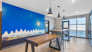 A modern interior with a wooden bench, pendant lights, and a large window. - Extended Stay America Premier Suites - Denver International Airport (Denver)