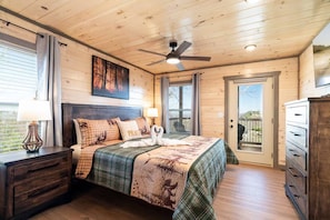 A bedroom with a wooden ceiling, a bed with a quilt, a nightstand, a dresser, and a ceiling fan. - Indoor Pool Cabin / Hot Tub / Close to Dollywood / Stay three & Play for Free (Sevierville)
