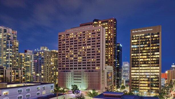 A high-rise hotel with multiple floors, a prominent sign for the Marriott Vacation Club, and adjacent buildings including The San Diego Union-Tribune.
