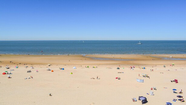 A wide beach with clear skies, a calm sea, and a few boats in the distance. - Stunning home in Oostduinkerke with WiFi (Oostduinkerke)