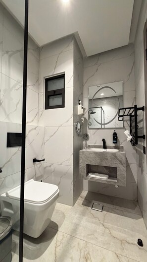 A modern bathroom with a toilet, bidet, and sink. - 003 Tara-jre Jabal Al Lweibdeh With Stunning View (Amman)