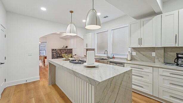 A modern kitchen with marble countertops, white cabinetry, and pendant lighting. - New 8bd 7.5ba 6,600 sq ft Home in O4W Inman Park WALKABLE ATL Eastside Beltline (Atlanta)