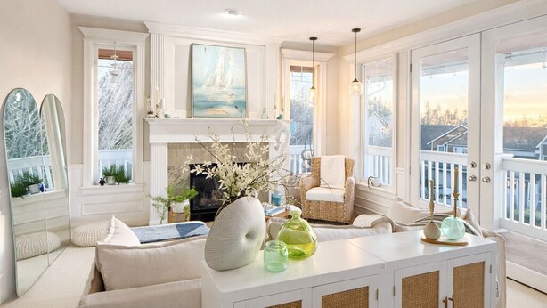 A spacious living room with a large window, a white sofa, a white cabinet, and a view of the outside. - Beautiful Eastside 5 bedroom resort like home with Hot-tub and AC (Newcastle)