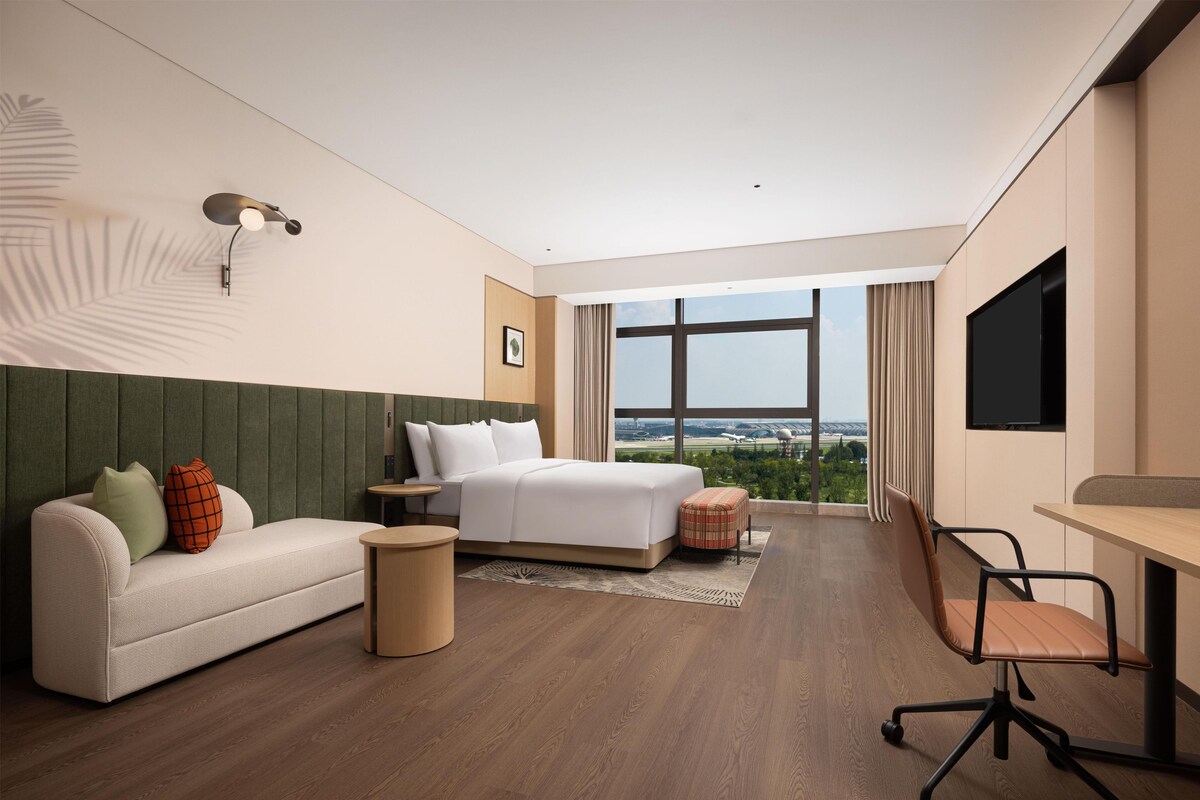 Room, 1 King Bed (Airport View) | Living area | LCD TV