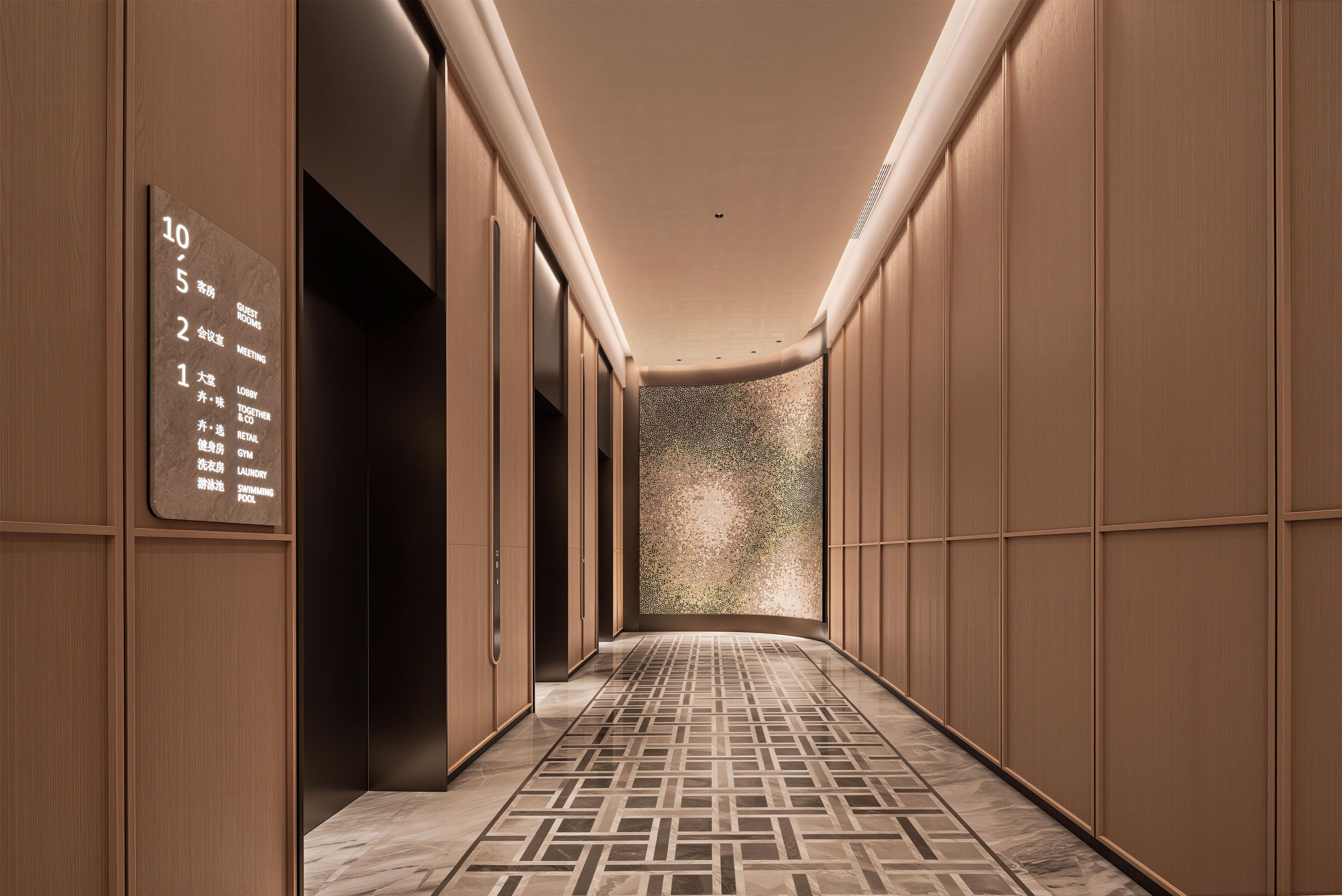 A hotel corridor with a floor plan sign indicating guest rooms, meeting rooms, and retail areas.