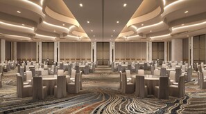 A conference room with round tables and chairs, a patterned carpet, and a modern ceiling design. - Hilton Lucknow Gomti Nagar (Lucknow)