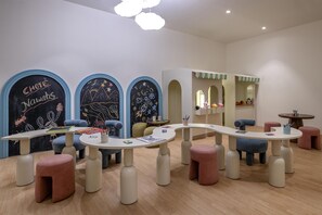 A children's play area with tables, chairs, and a chalkboard wall. - Hilton Lucknow Gomti Nagar (Lucknow)