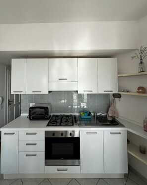 Private kitchen - Lovely beachfront studio apartment with balcony facing the sea (Lido delle Nazioni)