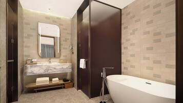 A modern bathroom with a large bathtub, a vanity with a mirror, and a shower area.