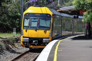 A yellow train labeled "Central" at a station platform. - KozyGuru | Brighton-Le-Sands | Luxury Bay View Apt (Brighton-Le-Sands)