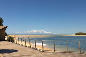 A wooden deck with a railing overlooking a beach. - 4/16 Leeding Terrace, Caloundra QLD 4551 (Sunshine Coast)