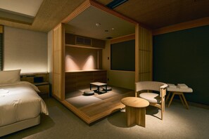 A minimalist room with a bed, a cat tree, a small table, and a chair. - Gion Kuromatsu (Kyoto)