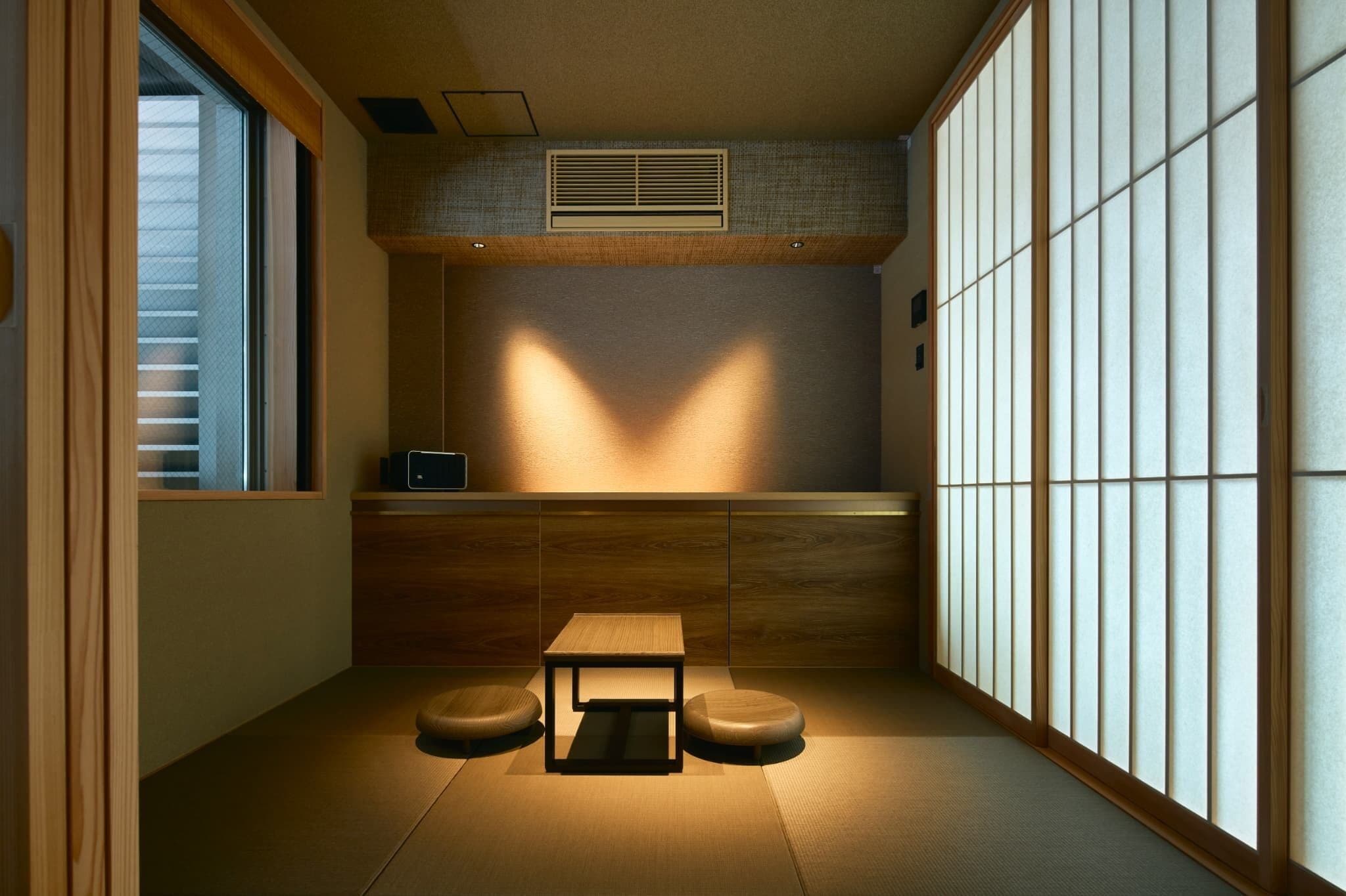 A traditional Japanese room with tatami flooring, a low table, and shoji screens.