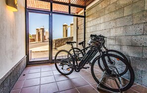 A bicycle parked inside a building with a view of stone structures outside. - Amazing home in Playa Blanca (Playa Blanca)