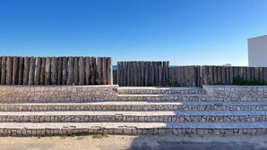 A set of stone steps leading up to a wooden fence. - Bonomi vacation home 15 meters from the beach (Porto Cesareo)