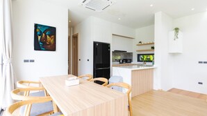 A modern kitchen with a black refrigerator, a microwave, and a coffee maker. - Aileen P3 V4 Saku Staycation (Sa Khu - Thalang)