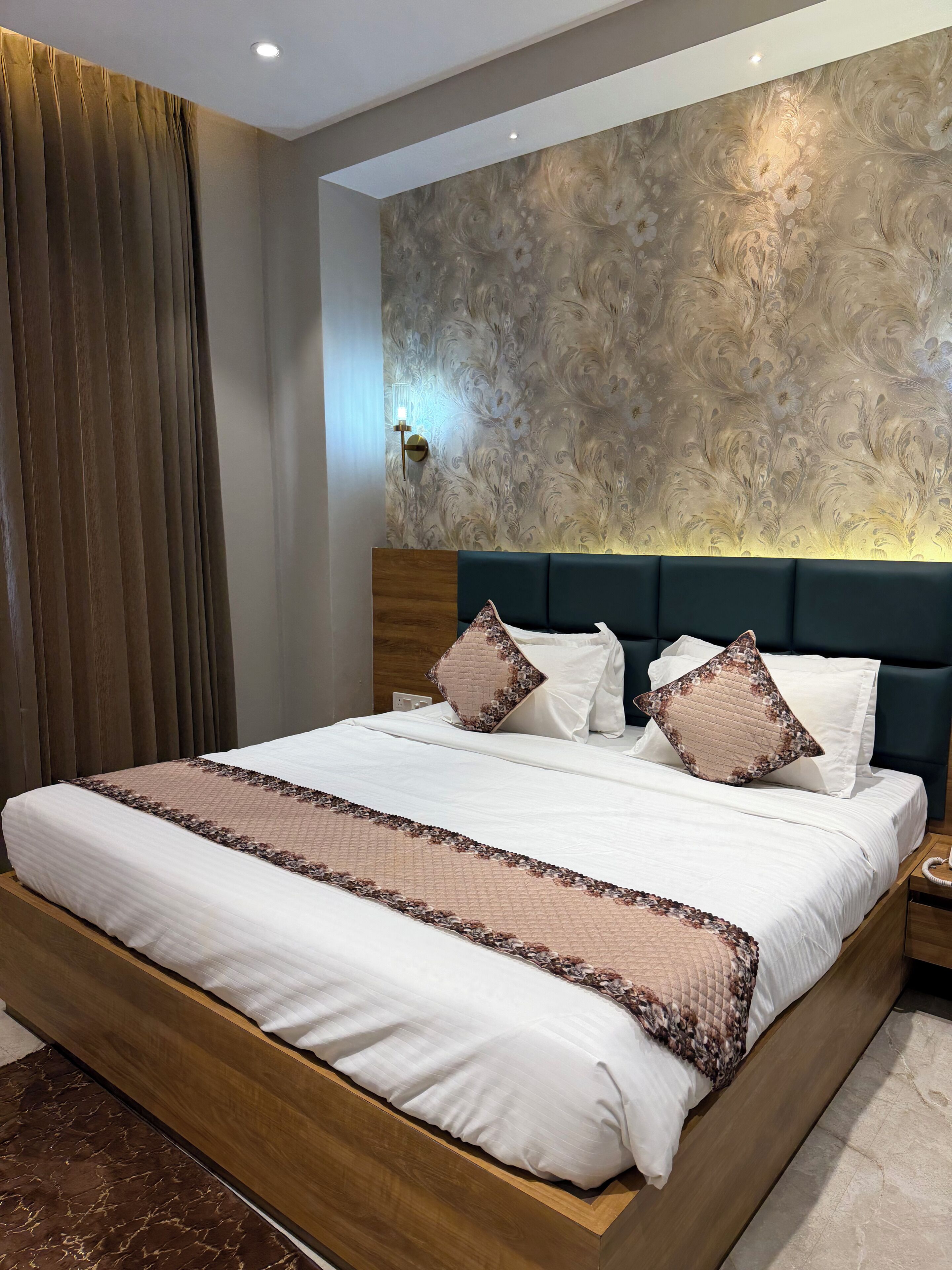 A neatly made bed with a wooden frame, a headboard, and decorative pillows.