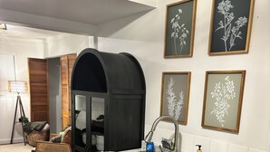 A compact kitchen with a built-in sink, wooden cabinets, and a black arch over the counter. - Fantastic 1-bedroom townhome apartment in Spokane perfect for your getaway (Spokane)
