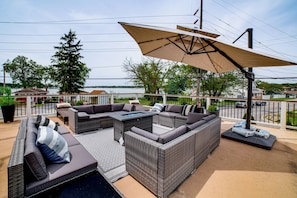 A patio with outdoor furniture, a pergola, and a view of a body of water. - Steps to Cedar Lake! Group Getaway w/ Game Room (Cedar Lake)
