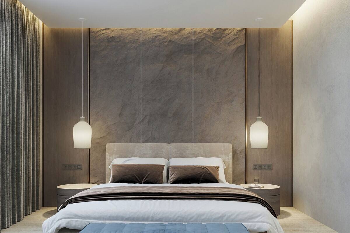 A modern bedroom with a large bed, two bedside tables, and a wall-mounted light fixture.