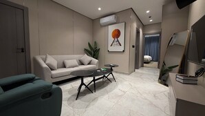 A modern living room with a sofa, coffee table, and a TV stand. - 002 tara-JRE Jabal Al Lweibdeh with stunning view (Amman)