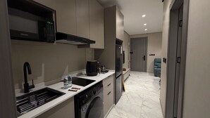 A modern kitchen with a dishwasher, a coffee maker, and a microwave. - 002 tara-JRE Jabal Al Lweibdeh with stunning view (Amman)