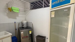 A small kitchenette with a refrigerator, a sink, and a trash bin. - Private Farm - Hot Pool, Jacuzzi & Games (Sopetrán)