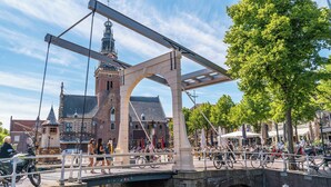 A historic bridge with a pedestrian walkway, a tower, and a canal. - Modern chalet with 2 bathrooms (West-Graftdijk)