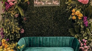 A green sofa, a wall with greenery and flowers, and a sign that says 'Happily Ever After'. - Luxury Content, Event and Rental House + Private Chef Experience - Casa Velour (Maricopa)