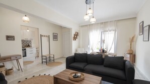 A modern living room with a sofa, coffee table, and dining area.
