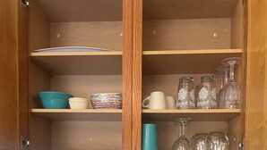 A kitchen with a microwave, wooden cabinets, and a knife block. - Awesome 1-bedroom apartment with AC in charming Page (Page)