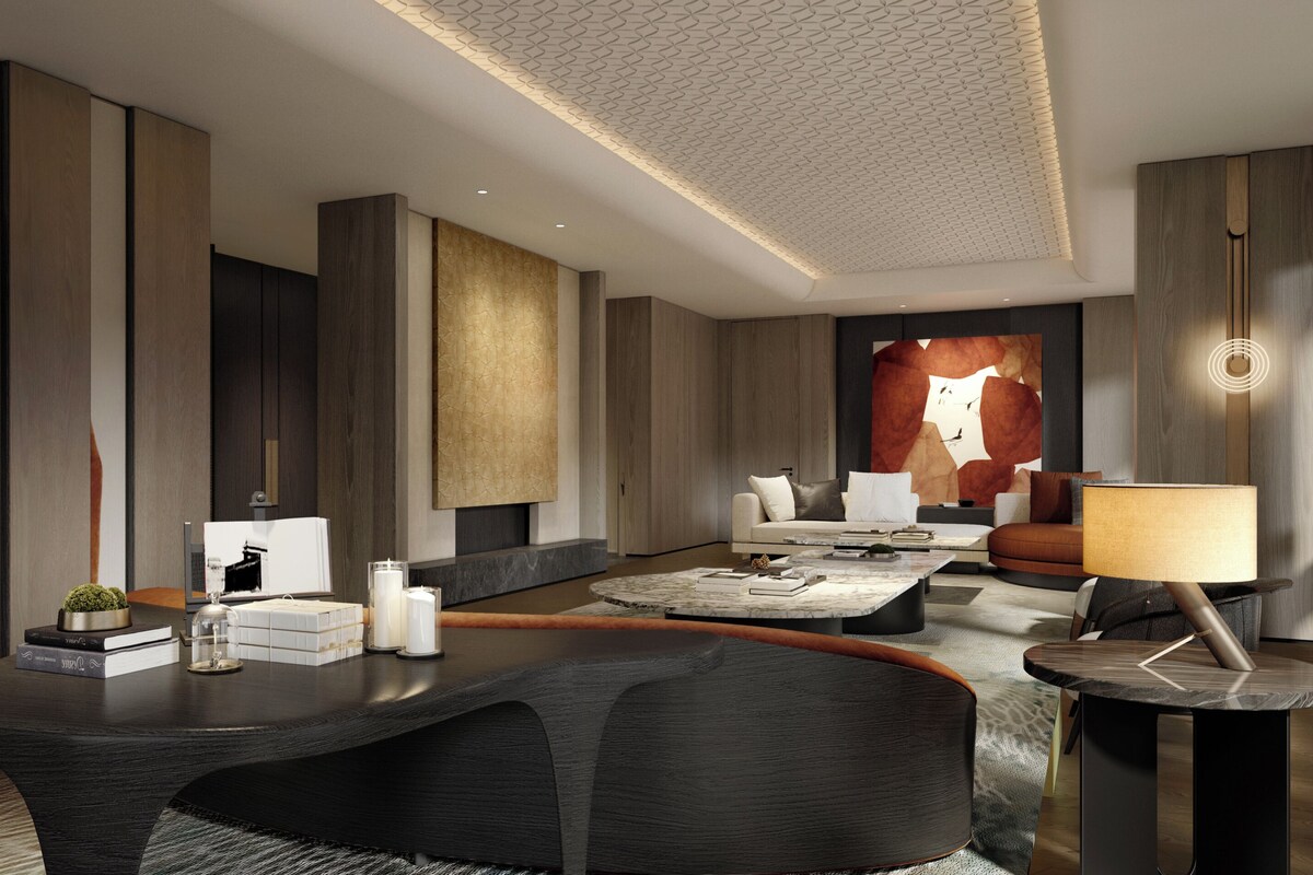 A modern living room with a sofa, coffee table, and lamp.