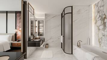 A modern bathroom with a marble floor, a bathtub, a sink, and a mirror.