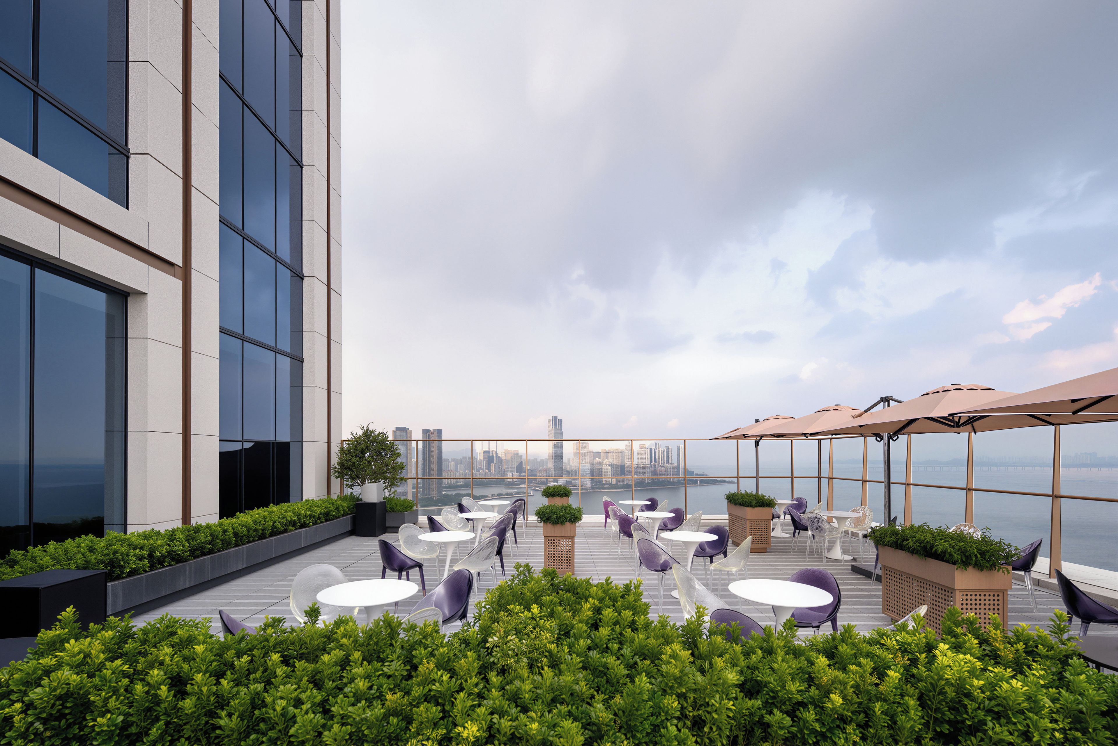 A rooftop terrace with outdoor seating and a city skyline view.