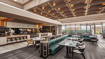 A modern restaurant interior with a high ceiling, wooden paneling, and a mix of seating options including booths and tables.
