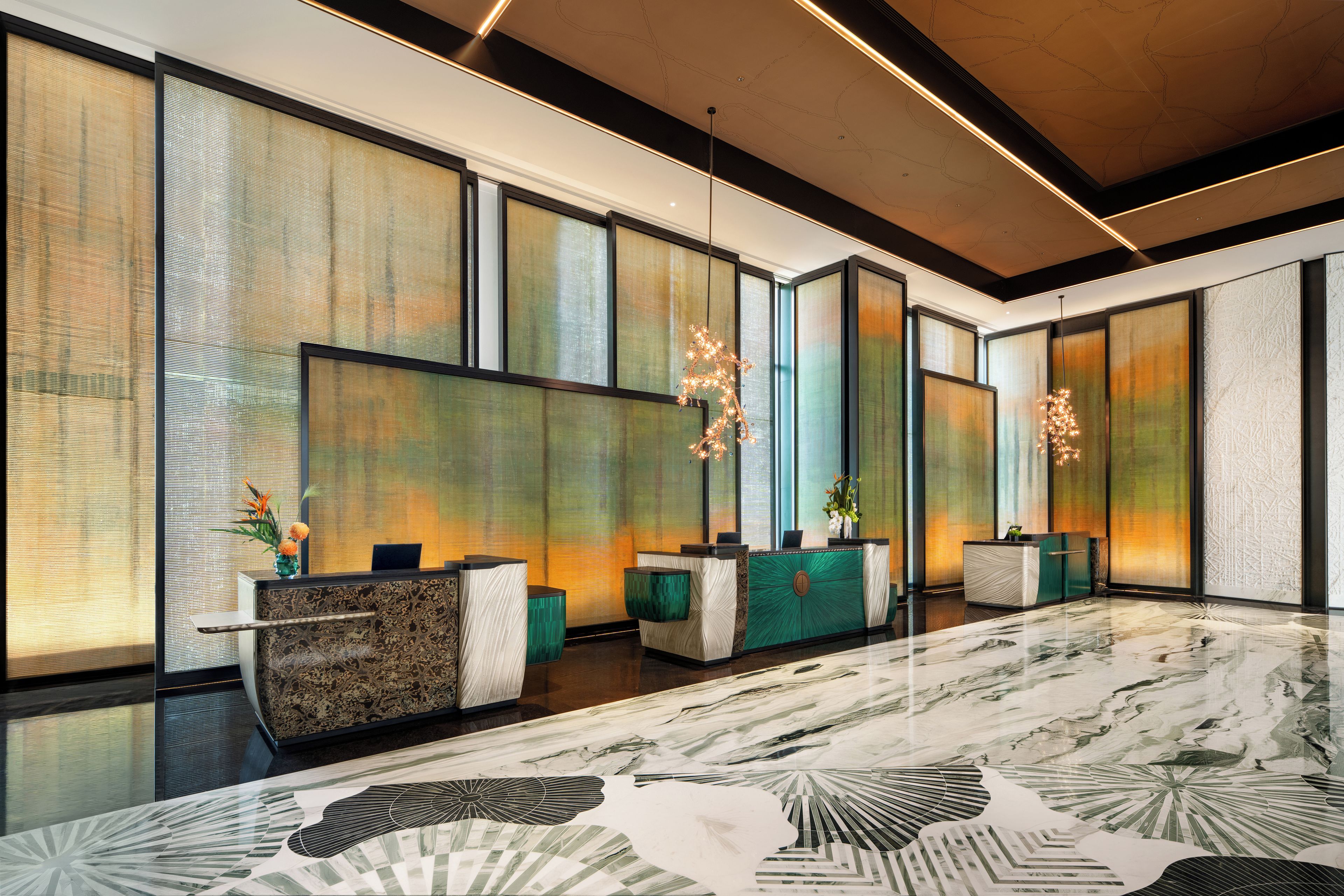 A modern reception area with a reception desk, seating, and decorative lighting.