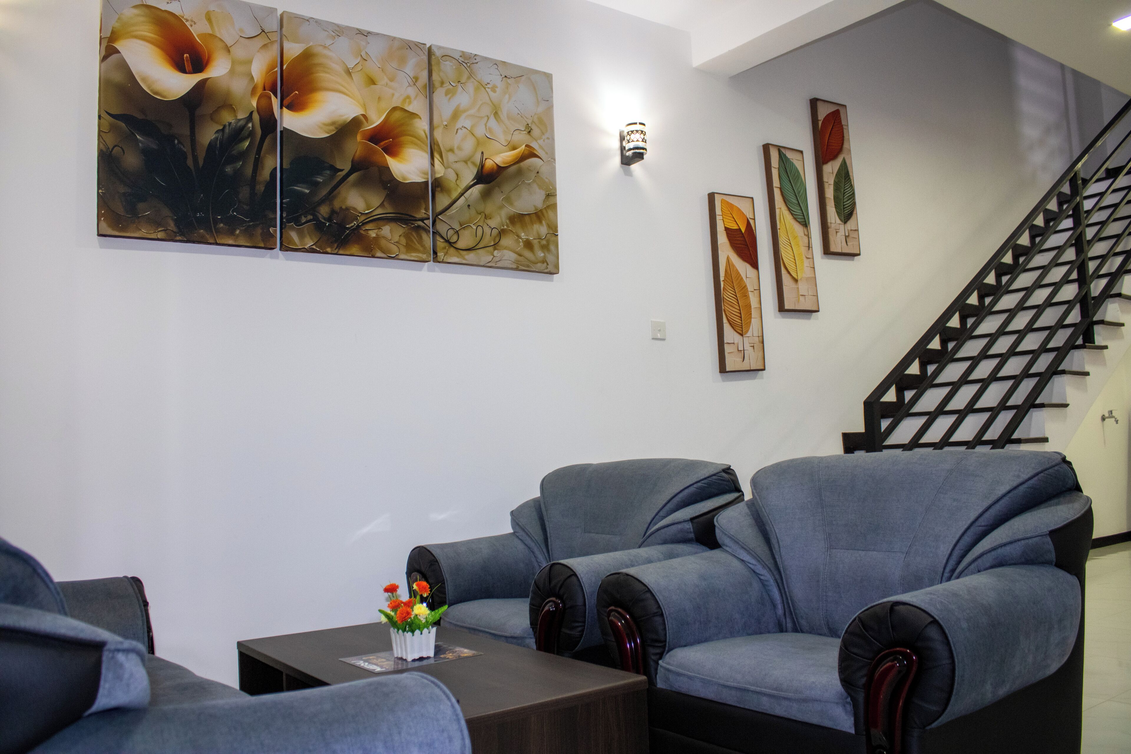 A seating area with two sofas, a coffee table, and wall art.
