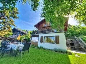 A chalet with a balcony, a dining area with outdoor seating, and a view of mountains. - Chalet Le Rhônasson by Interhome (Vercorin)