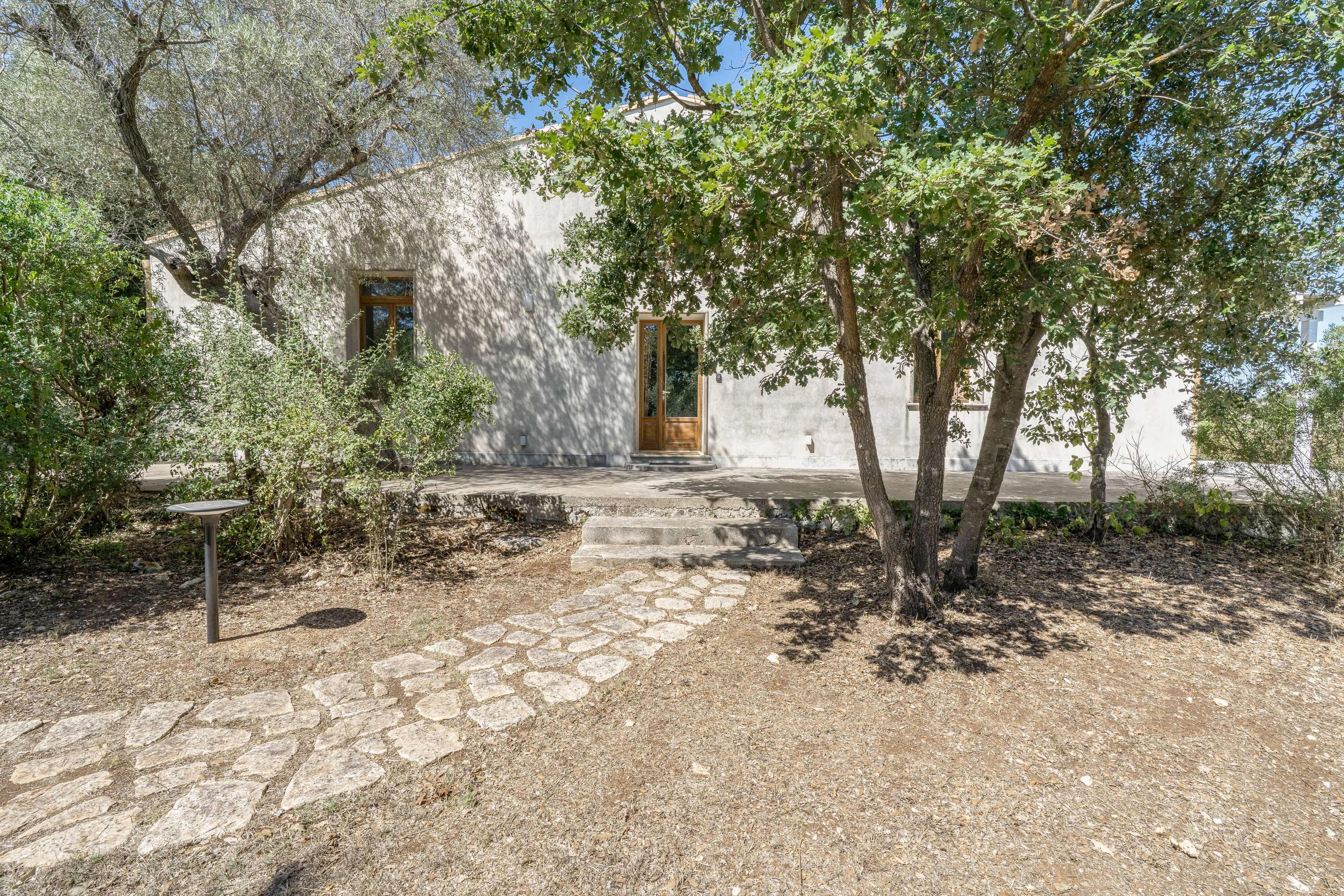 A building with a stone pathway leading to a wooden door.