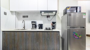 A compact kitchen with a built-in stove, a coffee maker, and a refrigerator. - VEE LUX BNB

Thindigua Finest (Nairobi)