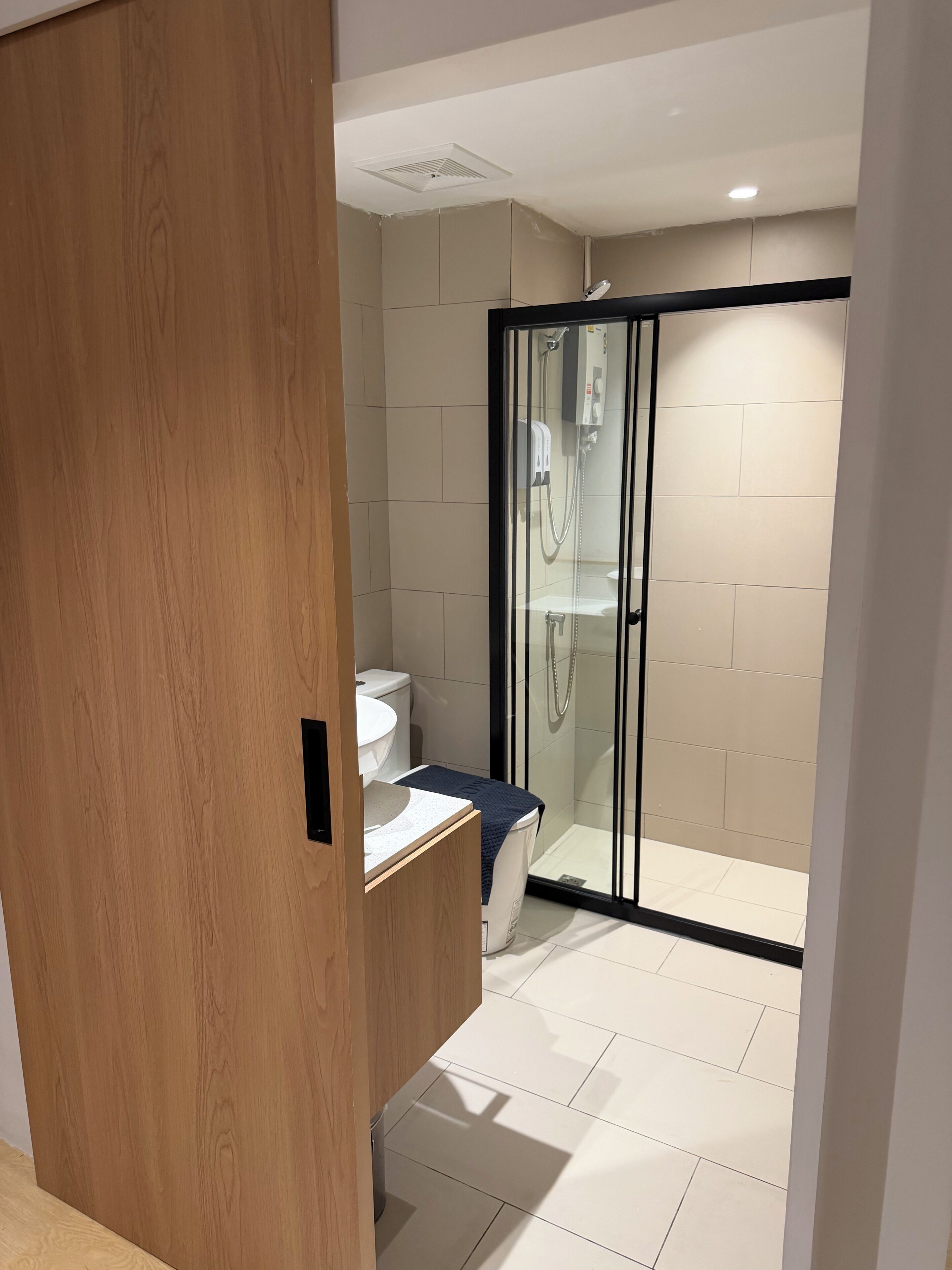 Un baño moderno con ducha, inodoro y lavabo.
