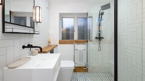 A modern bathroom with a white sink, mirror, and shower. - Tranquil Stoke-on-trent 4bed, 2 Bath, Parking (Stoke-on-Trent)