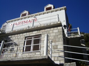 A building with a sign that reads 'PARTMAI' and a stone facade. - Josip Blue Horizon Apartments (Ston)