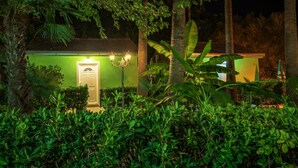 A building with a green facade, a white door, and a light fixture above it. - Nirvana Apartments & Auto Camp (Kumbor)
