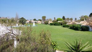 A well-maintained lawn with a fountain, surrounded by trees and buildings. - Pedras del Rei 8 (Pedrinhas del Rei) (Santa Luzia)