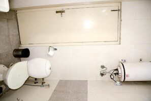 A bathroom with a toilet, a bidet, and a water heater. - Fortune Home Service Apartment 3Bhk,E-28 1B Saket (New Delhi)