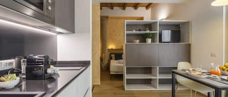 A modern kitchen with a microwave, coffee maker, and breakfast setup.