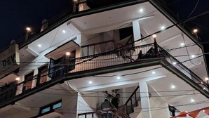 A multi-story building with balconies, staircases, and visible electrical wires. - Hotel shivdev (Uttarkashi)
