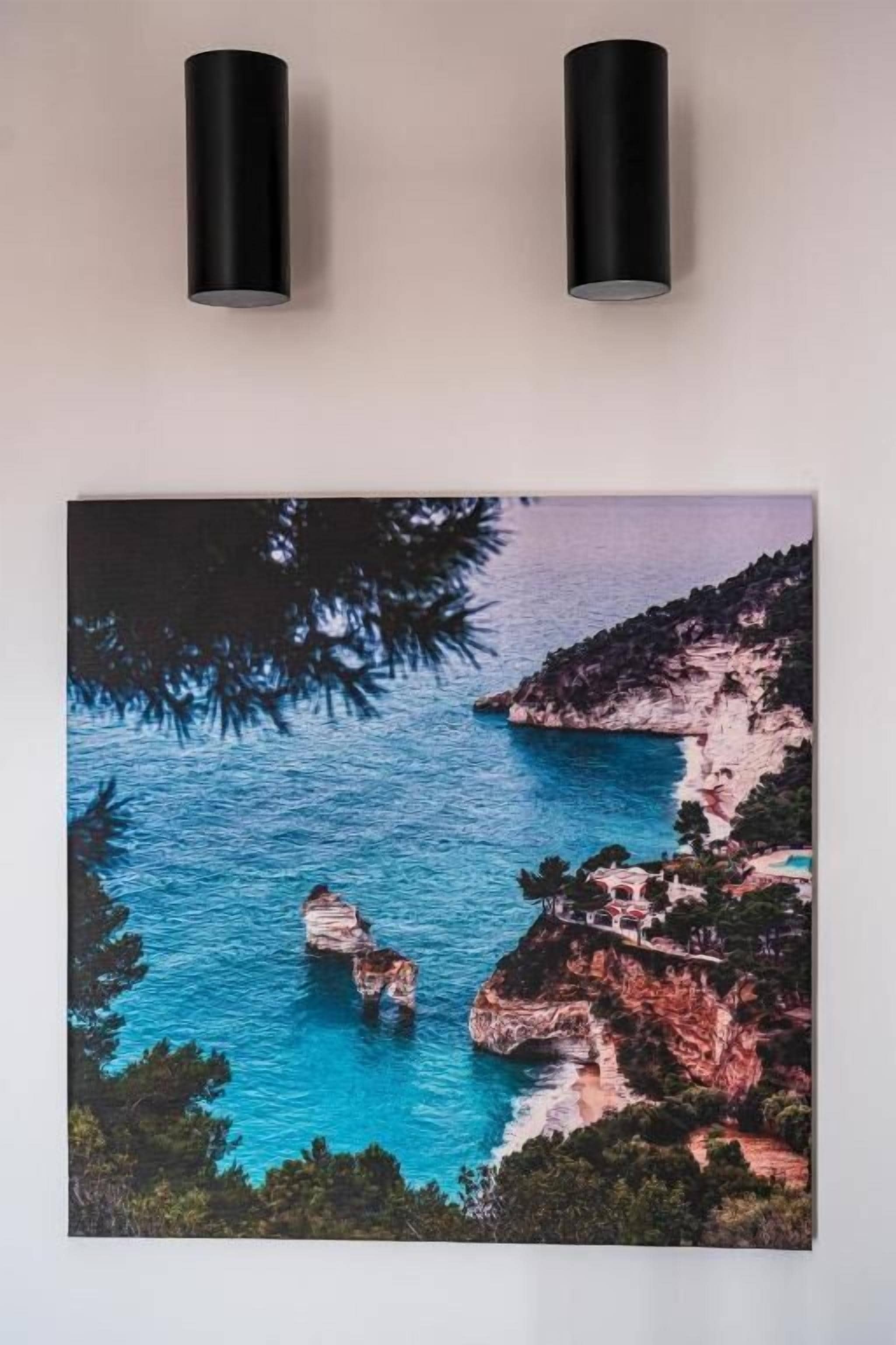 A framed coastal landscape with cliffs and a body of water.