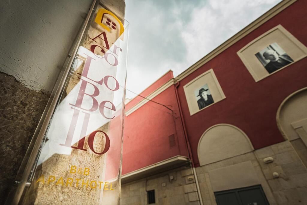 A building with a red facade and a sign that reads 'B&B PARTHOTEL.'